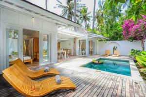 a villa with a swimming pool and a house at Villas Edenia - Luxe Villas with Private Pools in Gili Trawangan