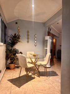 a dining room with a glass table and chairs at Le Cocon de Jade - Nylon Bastos in Yaoundé +21 photos