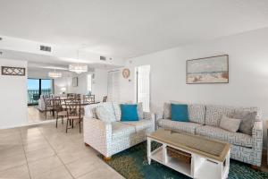 a living room with a couch and a table at Caprice Resort by Travel Resort Services in St. Pete Beach