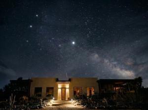 a house under a starry sky at night at Sacred Sands - Lobo Luna in Joshua Tree