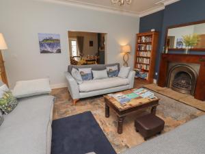 a living room with a couch and a coffee table at Number Seventeen in Amble