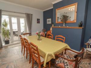 a dining room with a table and chairs at Number Seventeen in Amble