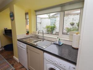 a kitchen with a sink and a window at Number Seventeen in Amble +22 photos