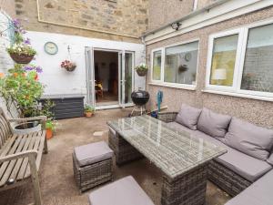 a patio with a couch and a table at Number Seventeen in Amble