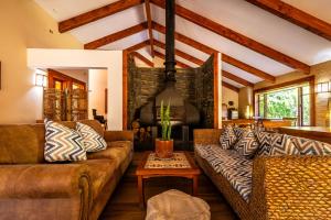 a living room with two couches and a table at Hotel Boutique Refugio El Molle in El Molle