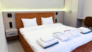 a bedroom with a bed with towels on it at Нова Дача in Kozintsy