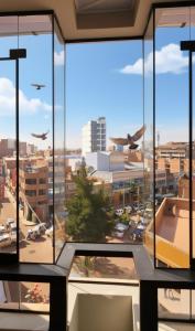 an office window with views of a city and planes at APART SExTA ESTACIÓN in Juliaca