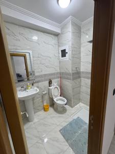 a bathroom with a toilet and a sink at Alhoceima - vue sur la mer- Green village2 in Al Hoceïma +44 photos