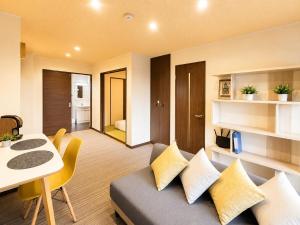 a living room with a couch and a table at Vieuno Hida Takayama 5-Min Walk to Station, Cozy Local Stay in Takayama