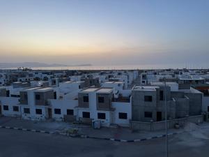 an aerial view of a city with white buildings at Alhoceima - vue sur la mer- Green village2 in Al Hoceïma