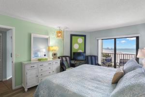 a bedroom with a bed and a view of the ocean at Caprice Resort by Travel Resort Services in St. Pete Beach +83 photos