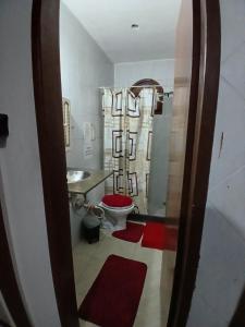 a bathroom with a toilet and a sink and a mirror at Pousada Familiar 31 in Campos dos Goytacazes +30 photos