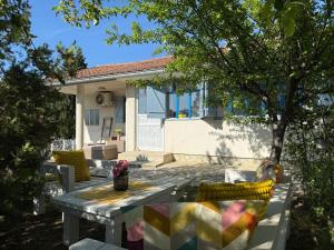 a patio with a table and chairs in front of a house at Ottov Raj Na Dunavu in Krčedin