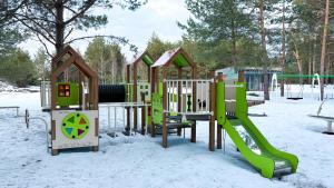 a row of playground equipment in the snow at Нова Дача in Kozintsy
