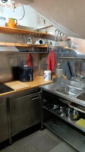 a kitchen with a sink and a counter top at Villa Régio Studio in Vila do Conde
