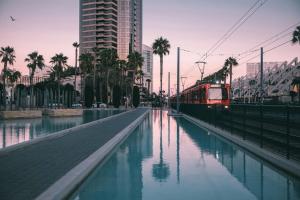 a train is traveling down a canal in a city at California Dreams Hostel - Downtown in San Diego