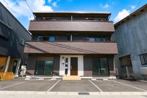 a brick building with a tower on top of it at Vieuno Hida Takayama 5-Min Walk to Station, Cozy Local Stay in Takayama