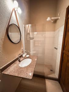 a bathroom with a sink and a shower with a mirror at Pousada Alto do Vale in Nova Friburgo +74 photos