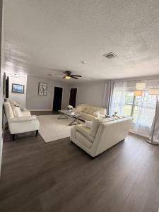 a living room with two white couches and a table at my place to be in Port Charlotte