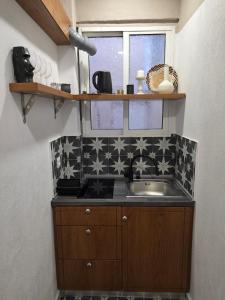 a small kitchen with a sink and a window at Levanta apartment in Asprovalta +56 photos