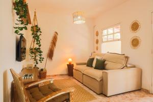 a living room with a couch and a table at Casa Laguna - Geribá in Búzios +41 photos