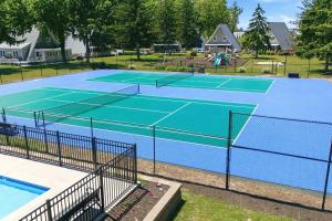 a tennis court with two tennis courts at Chalet #36 The Perfect View in Stevensville