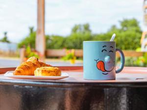 a coffee cup and a plate of bread on a table at greet Hotel Belleville en Beaujolais A6 in Belleville-sur-Saône +54 photos