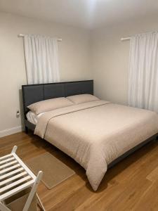 a bedroom with a large bed with white sheets at Homestead Bungalow in Dayton
