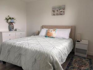 a bedroom with a bed and a vase of flowers at Bridge View near Confederation Bridge and beaches in Borden-Carleton