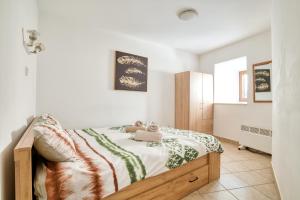 a bedroom with a bed with a teddy bear on it at Historic Old Town Kotor in Kotor