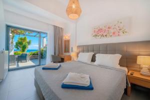 a bedroom with a bed with a view of the ocean at Barbati Beachfront - Pool Villa in Barbati