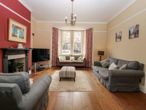 a living room with two couches and a tv at Tilly's Retreat in Hunstanton