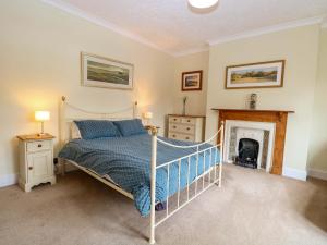 a bedroom with a bed and a fireplace at Tilly's Retreat in Hunstanton