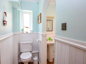 a bathroom with a white toilet and a sink at Tilly's Retreat in Hunstanton +41 photos