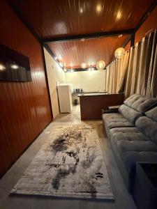 a living room with a couch and a rug at Vila do Tênis in Guaratinguetá