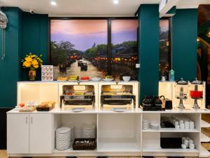 a kitchen with a counter with food on it at Hanoi Silk Classy Hotel & Travel in Hanoi
