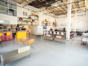 a large room with tables and chairs and a cafeteria at Ibis Serra Talhada in Serra Talhada