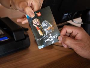 a person holding a book in front of a desk at Ibis Serra Talhada in Serra Talhada