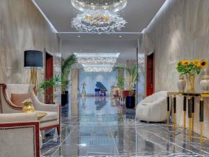 a living room with a chandelier and a lobby at Movenpick Hotel Centaurus Islamabad in Islamabad