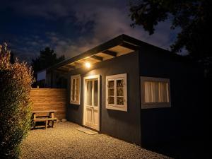 a small house with a bench in front of it at Cabaña bosquepaz in Algarrobo +7 photos