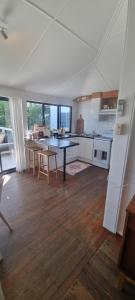 a kitchen with a table and chairs in a room at Ocean High in Yamba
