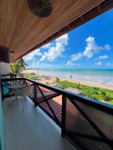a balcony with a view of the beach at Pousada Grandmar, Maragogi in Maragogi