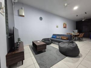 a living room with a couch and a table at Lim'S Homestay Kudat in Kudat
