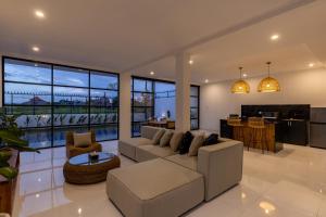 a living room with a couch and a table at Villa Alba by Orivista, Rice Field View in Dalung