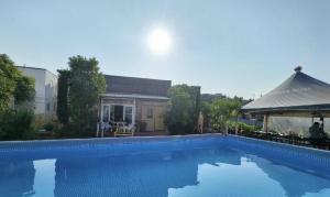 a large blue swimming pool next to a building at Paju Seolreda in Paju