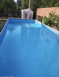 a large blue swimming pool with a gazebo at Paju Seolreda in Paju