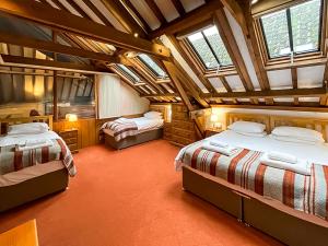 a bedroom with three beds in a room with skylights at Granary - Uk51016 in Louth