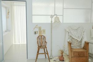 a room with a wooden chair and a lamp at Seesun Art Studio Villa in Ansan