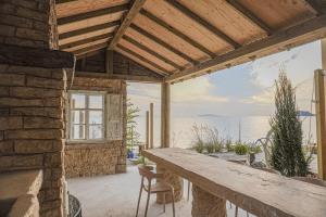 a patio with a table and chairs and a large window at Seesun Art Studio Villa in Ansan