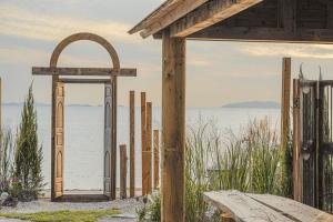 a wooden archway in front of a body of water at Seesun Art Studio Villa in Ansan